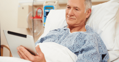 patient in bed with tablet 
